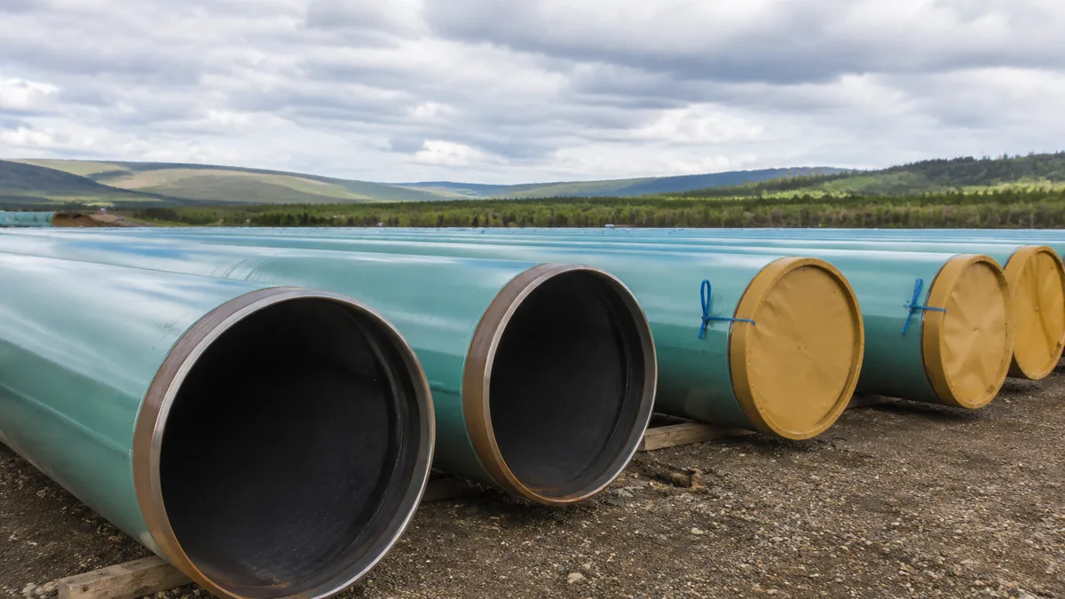 Large coated steel line pipes stored with protected ends before installation