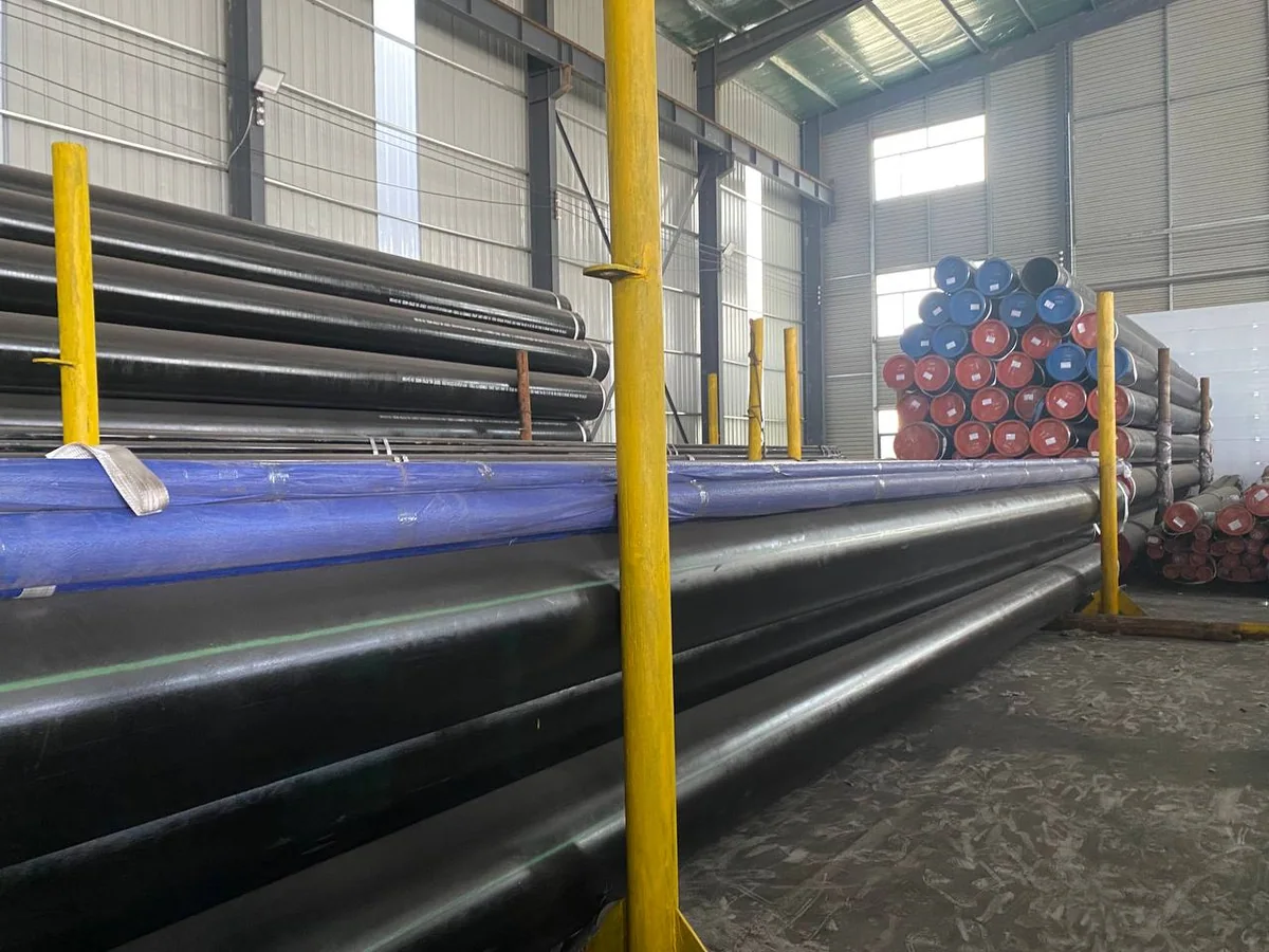 Black coated steel pipe stock staged by lot inside the warehouse