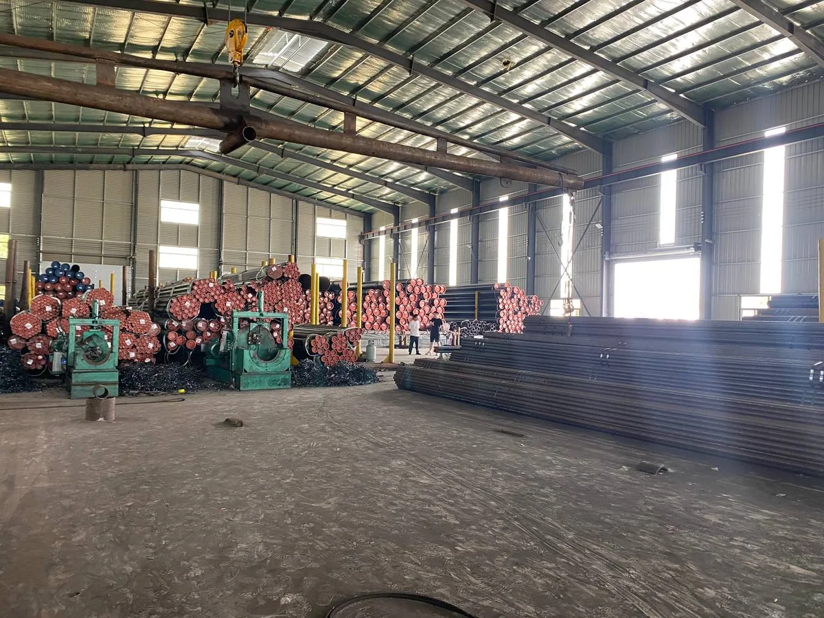 Carbon steel pipe bundles and pipe ends staged in a warehouse